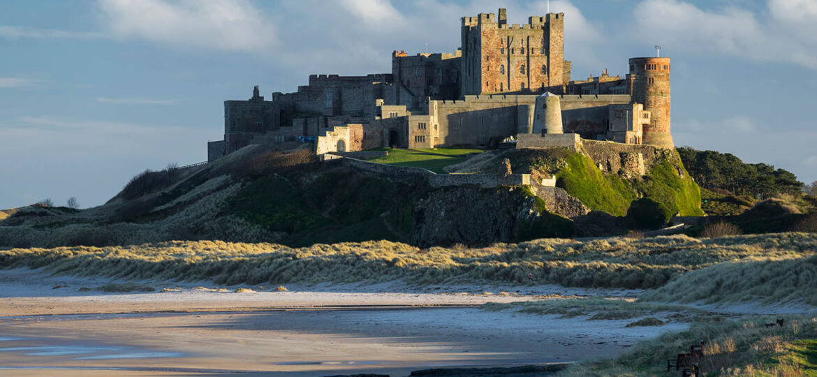 Bamburgh Castle lit by the last light of a winters's evening, Northumberland